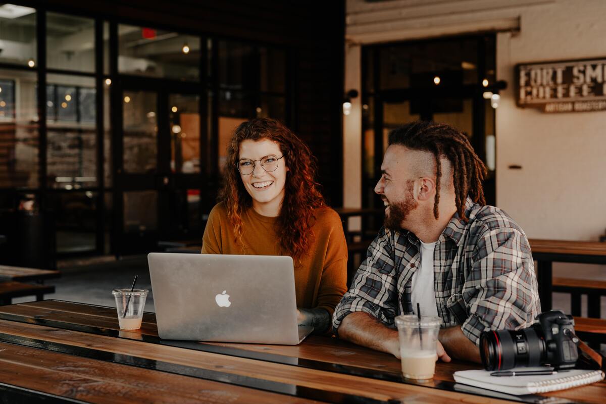 Man and woman siting in front of a laptop